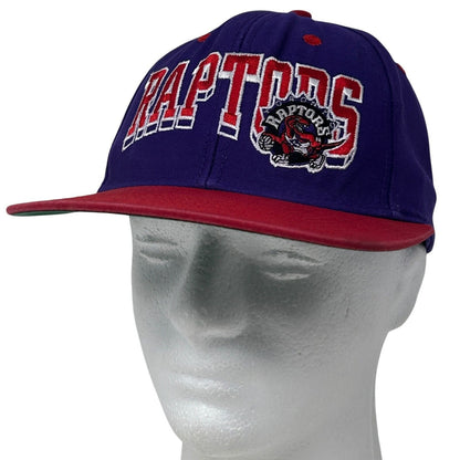 Front view of purple adidas Toronto Raptors snapback hat with embroidered logo and red brim