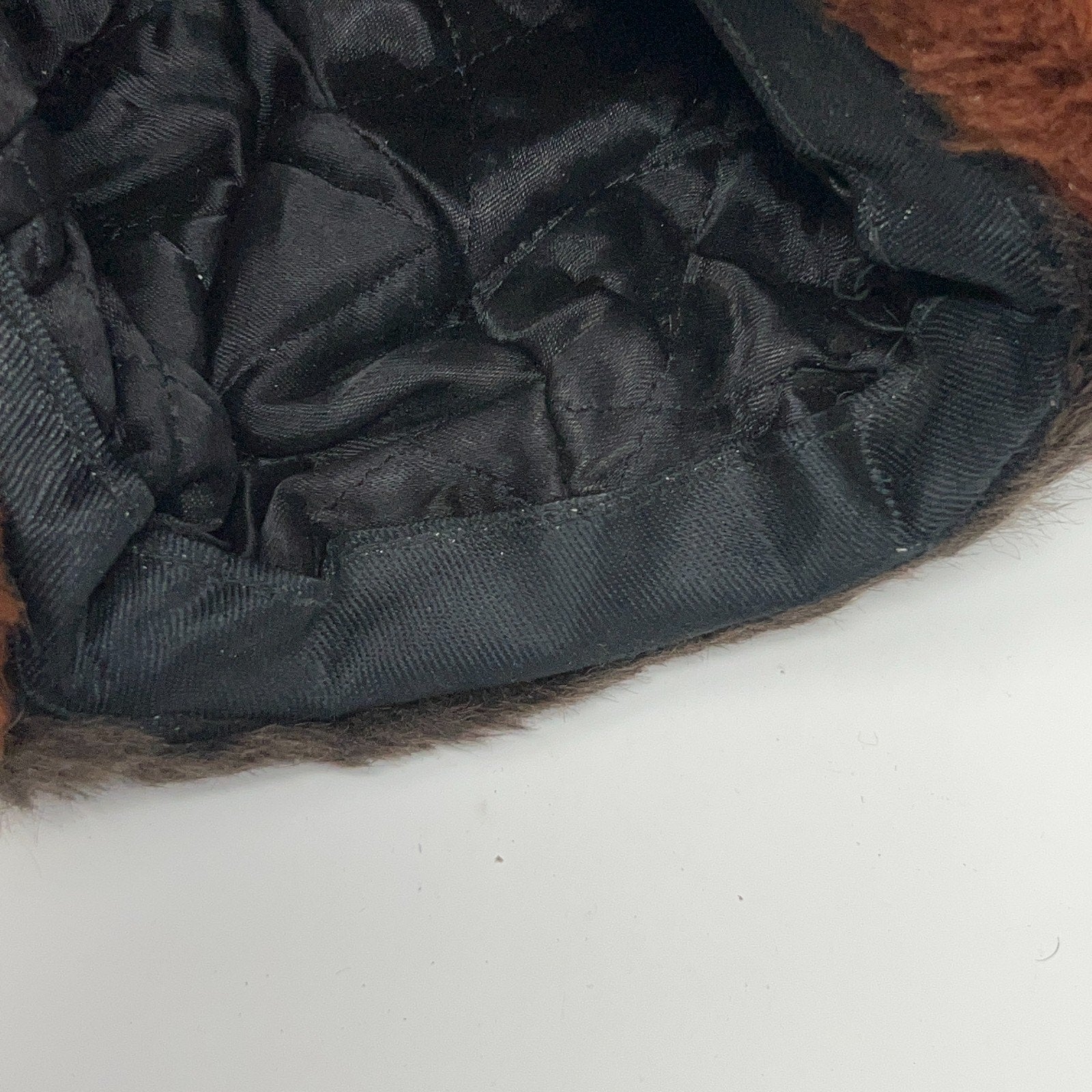 Vintage 1970s brown trapper hat interior view with quilted lining