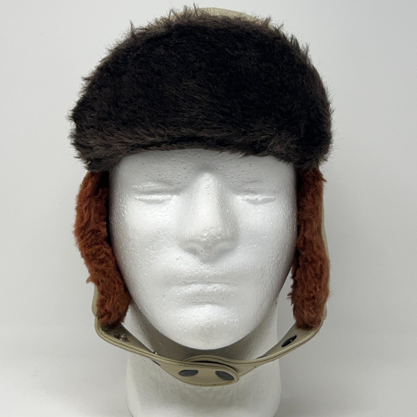 Vintage 1970s trapper hat in black and brown with ear flaps, displayed from the front