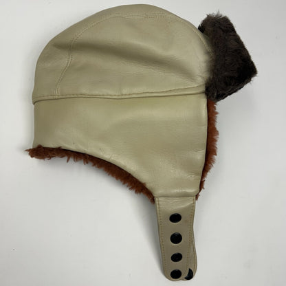 Vintage 1980s beige trapper hat with fur lining and ear flaps in side view