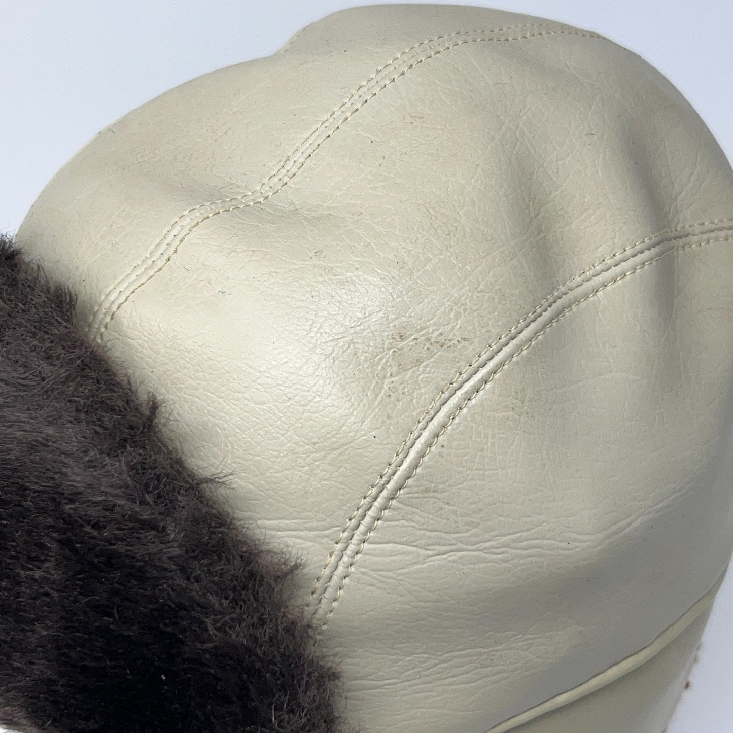 Vintage 1980s cream trapper hat with black fur lining, front view
