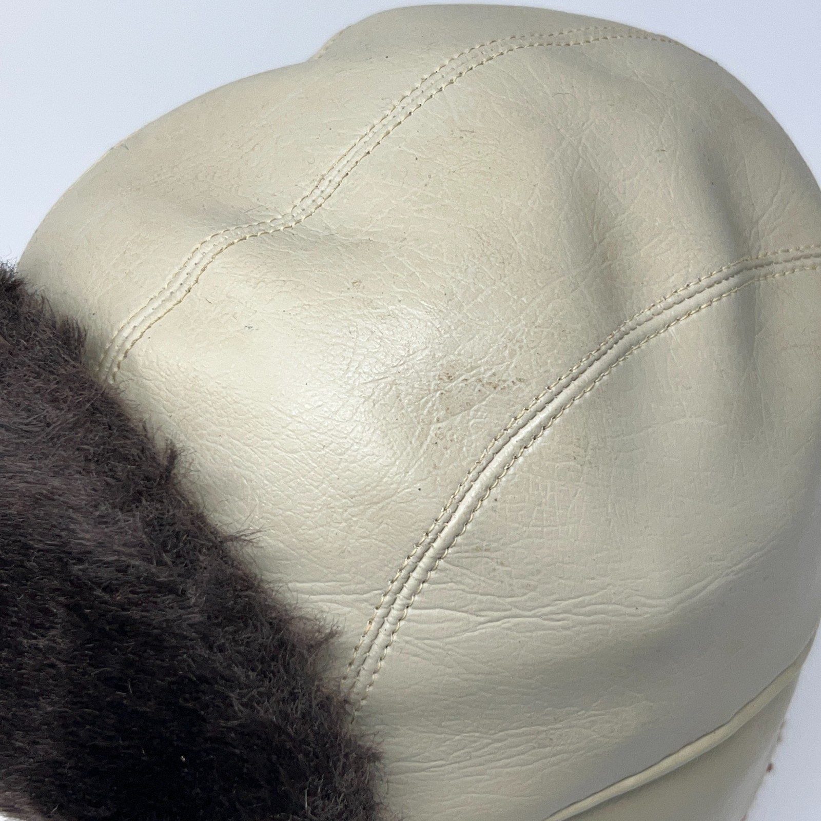 Vintage 1980s cream trapper hat with black fur lining, front view