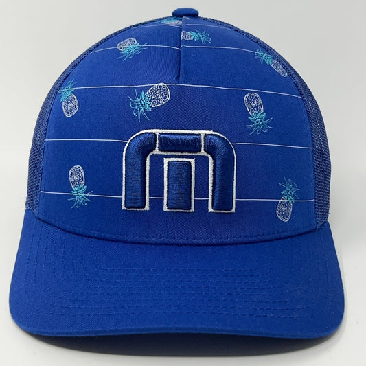 Travis Mathew blue trucker hat featuring pineapple pattern and front logo detail