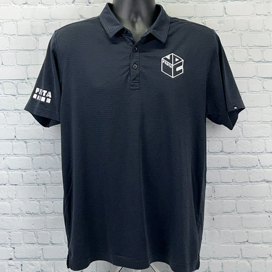 Travis Mathew Polo in black, short-sleeve, front view with logo on chest and sleeve detail