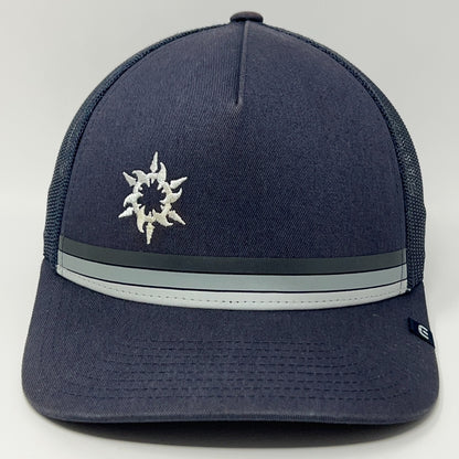 Travis Mathew Spanish Trail navy baseball cap with embroidered logo and gray striped detail on the front