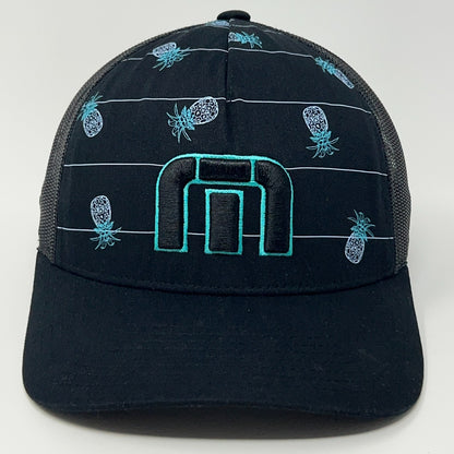 TravisMathew black trucker hat with blue pineapple pattern and distinctive logo