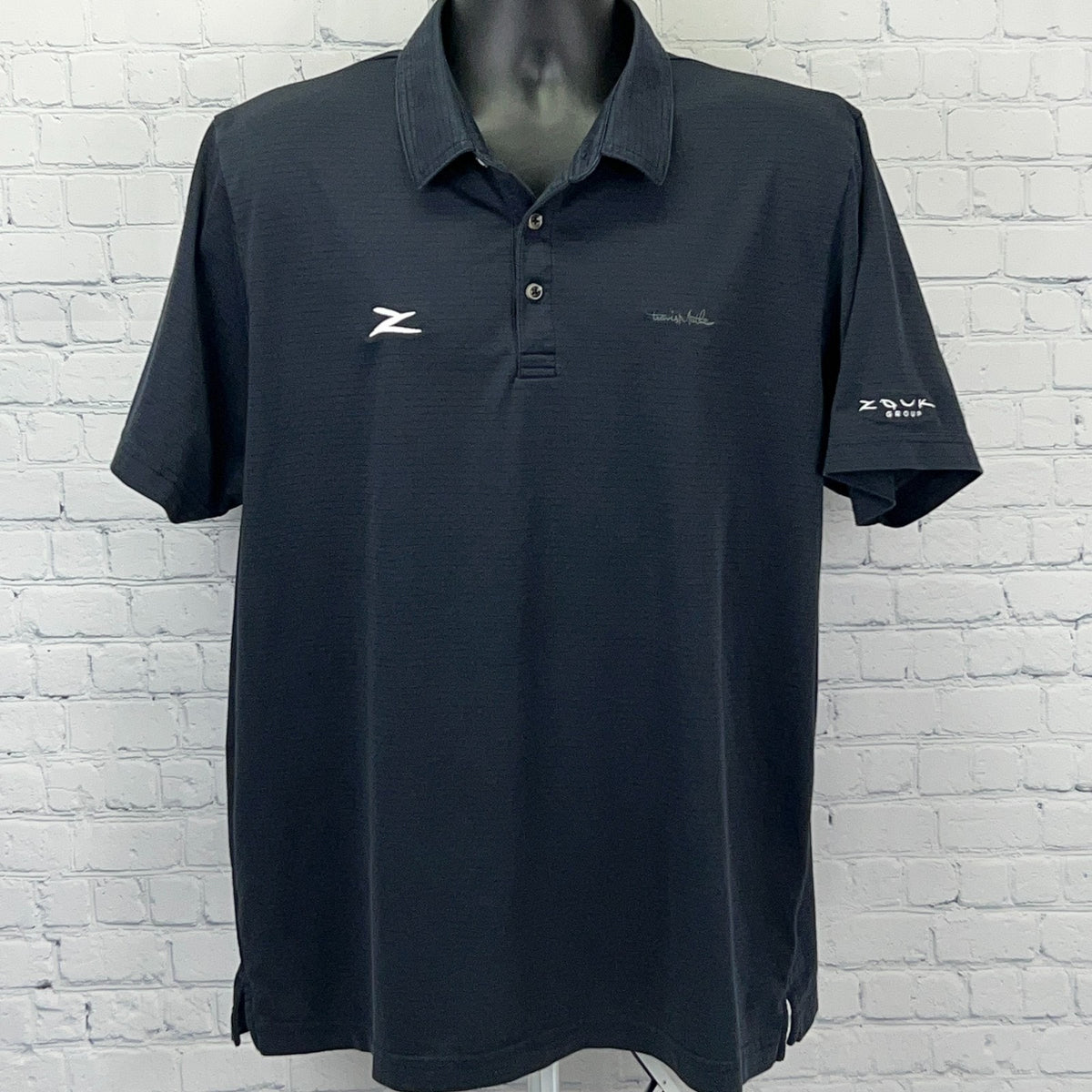 TravisMathew men's golf polo shirt in blue with short sleeves and embroidered logo