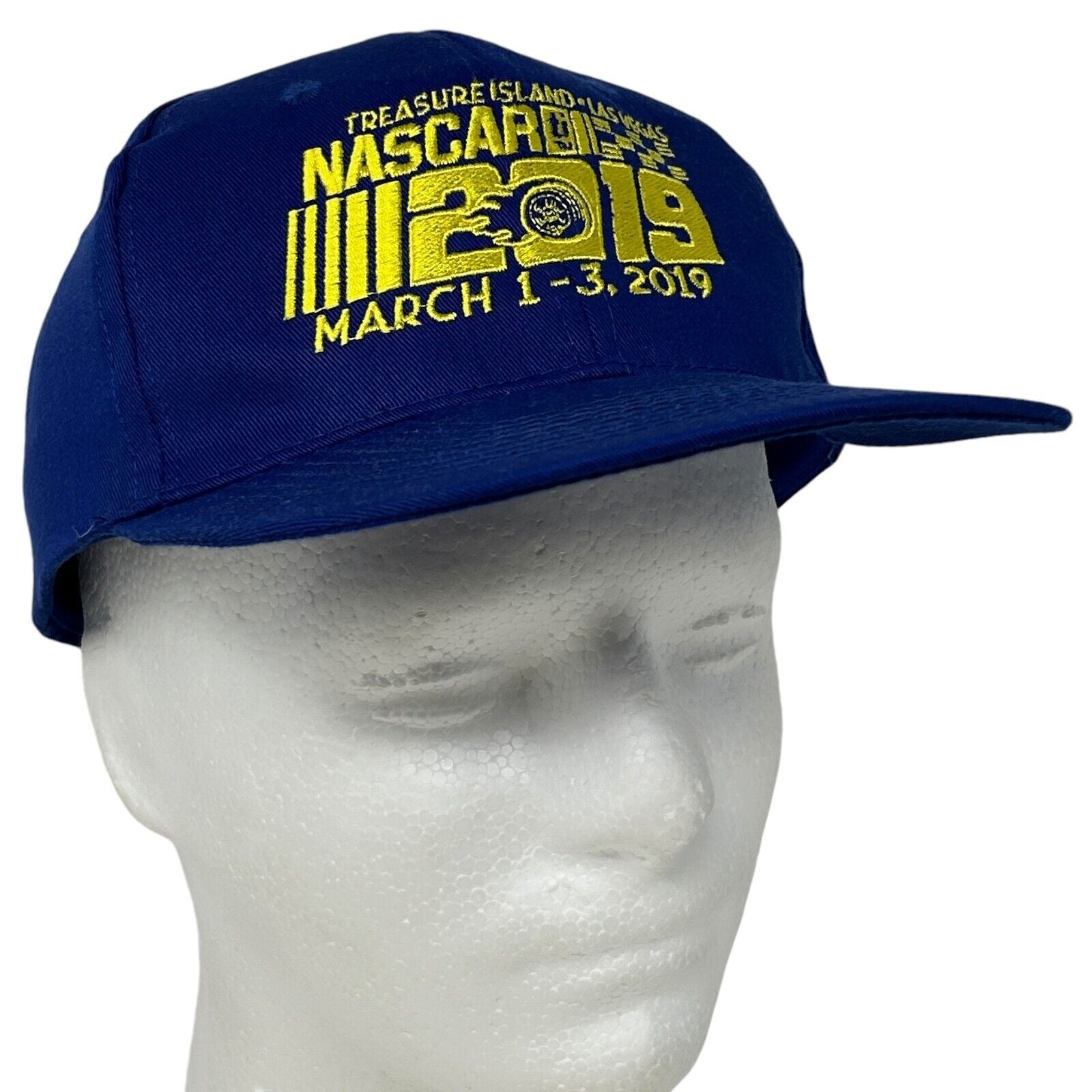 Navy blue Hit Wear NASCAR cap featuring the Treasure Island logo and event dates embroidered on the front