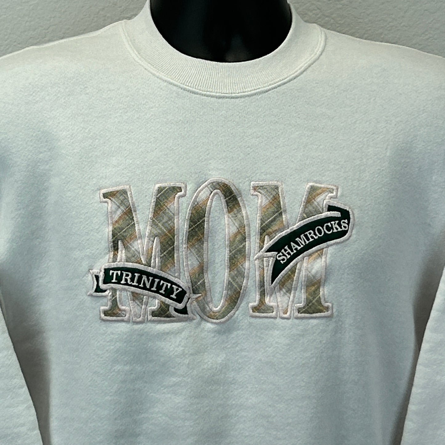 Vintage white sweatshirt featuring Trinity Shamrocks embroidered with a plaid design
