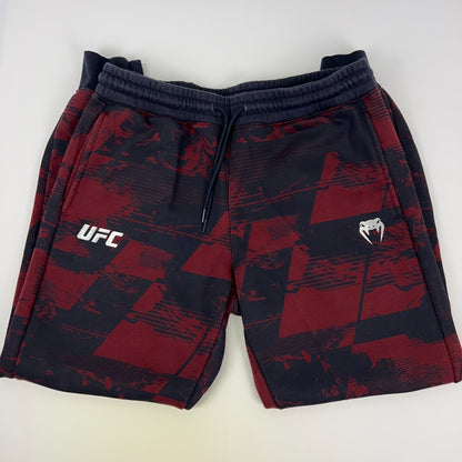 Red and black UFC Venum shorts featuring logo, front view, ideal for training and casual wear
