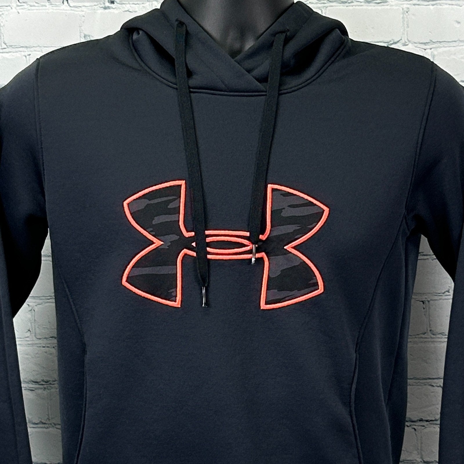 Front view of Under Armour Hoodie in black with orange logo and drawstring hood
