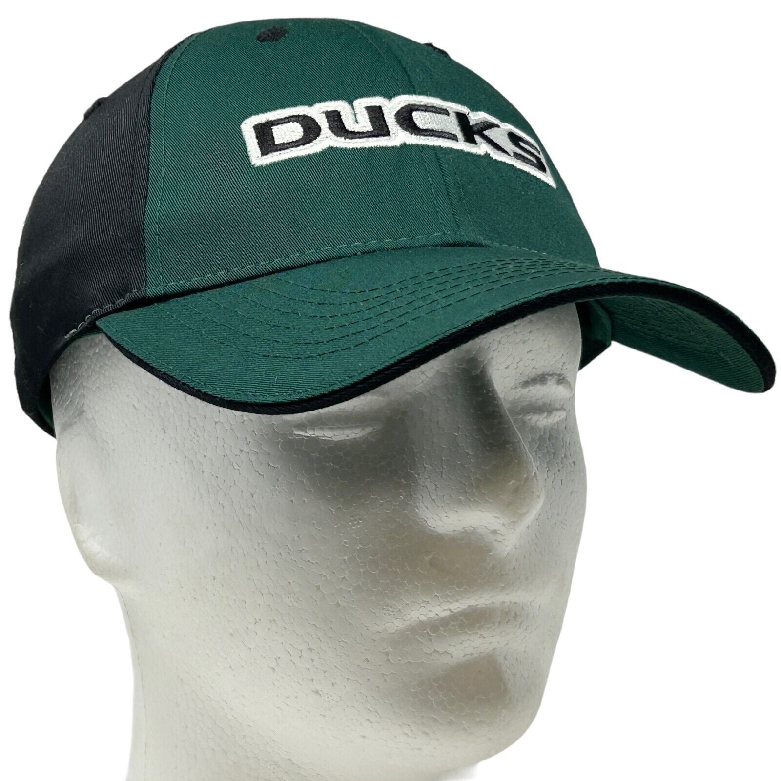 Front view of green and black Captivating Headwear cap featuring University of Oregon Ducks logo in white