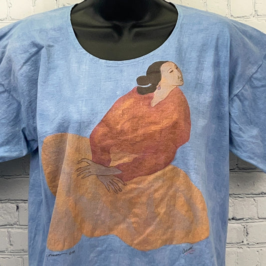 Vintage Native American graphic t-shirt featuring a colorful woman in a red dress on a light blue background