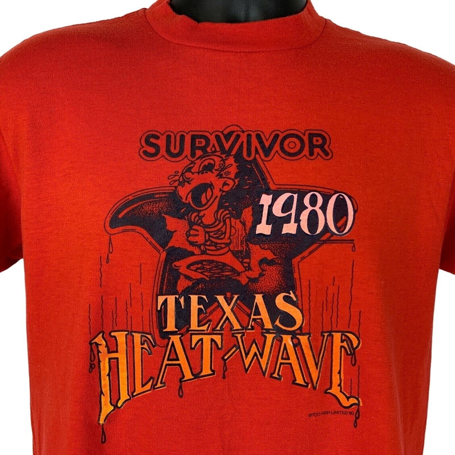 Vintage red T-shirt featuring Texas Heat Wave graphic and Survivor 1980 text, front view.
