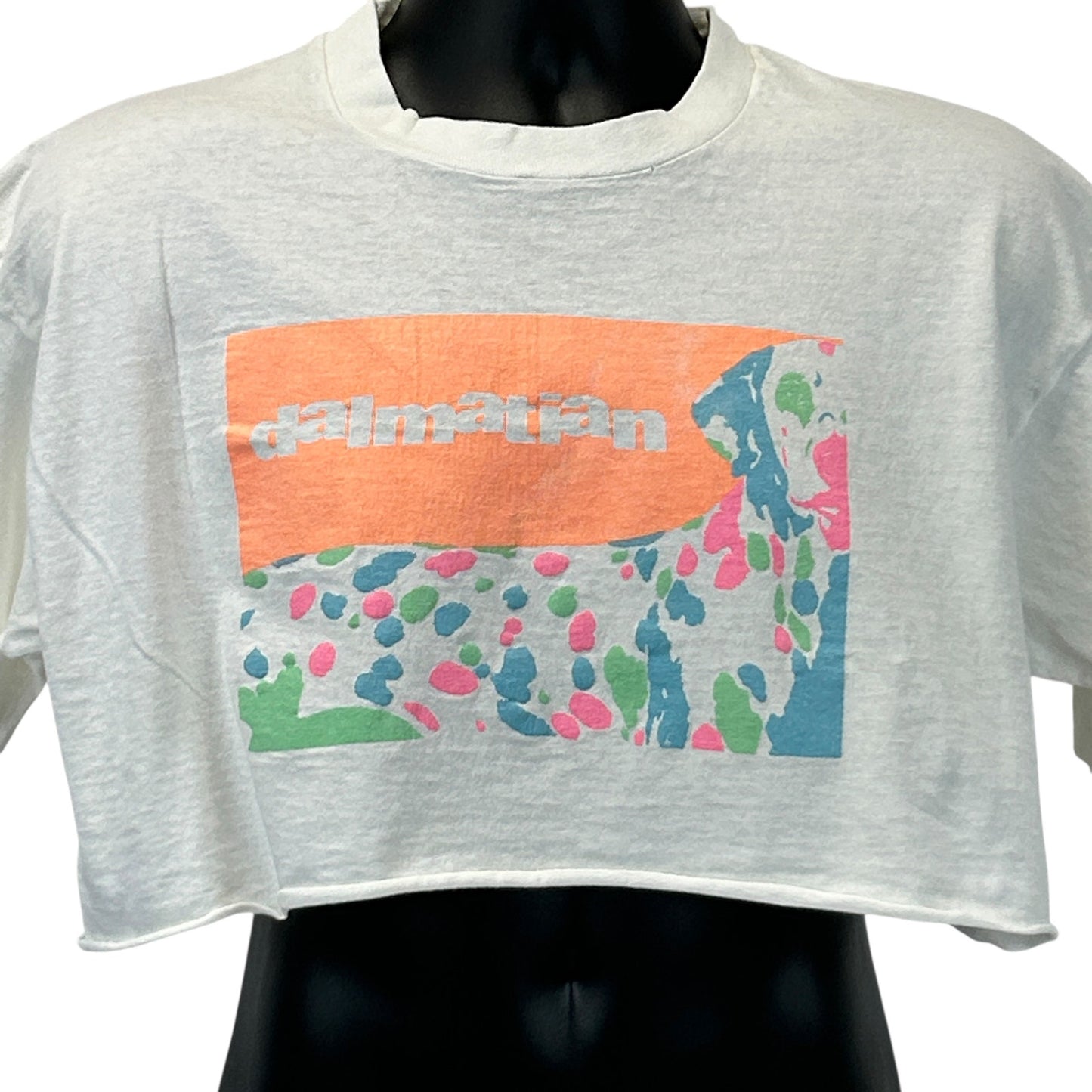 White cropped T-shirt featuring a colorful Dalmatian graphic on the front, perfect for casual wear.