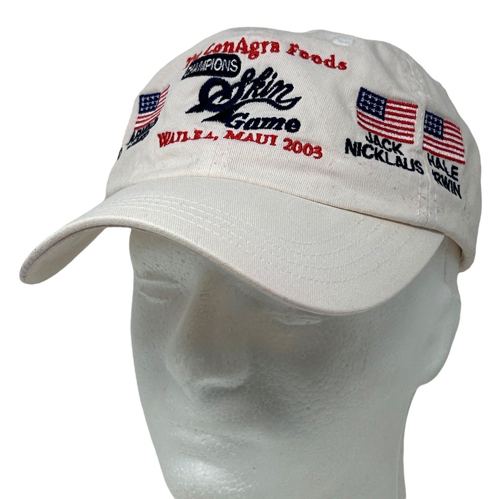 White Imperial golf cap with embroidered USA flags and text from the 2003 Champions Skin Game