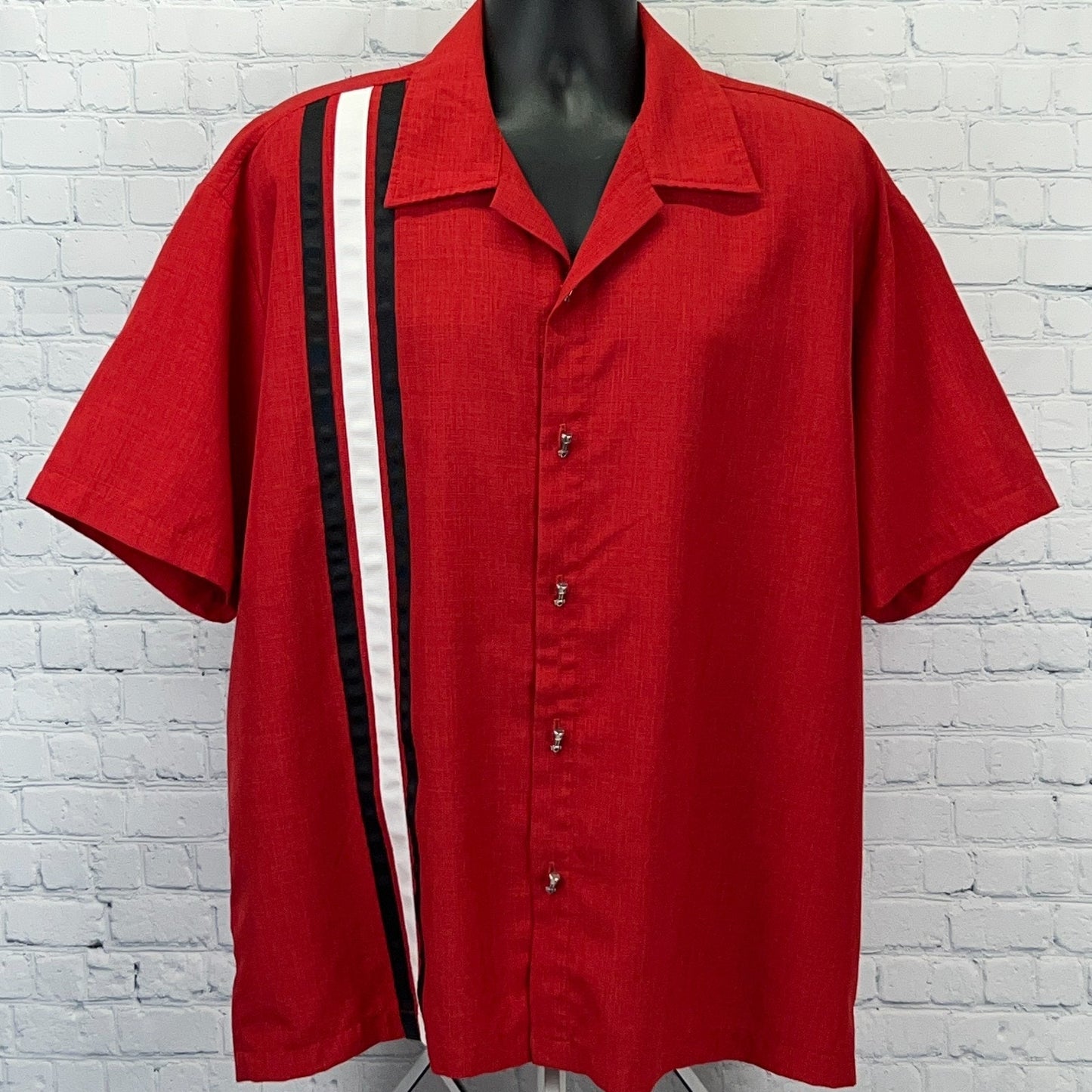 Red short-sleeve button-up shirt with a black and white side stripe, featuring a classic collar