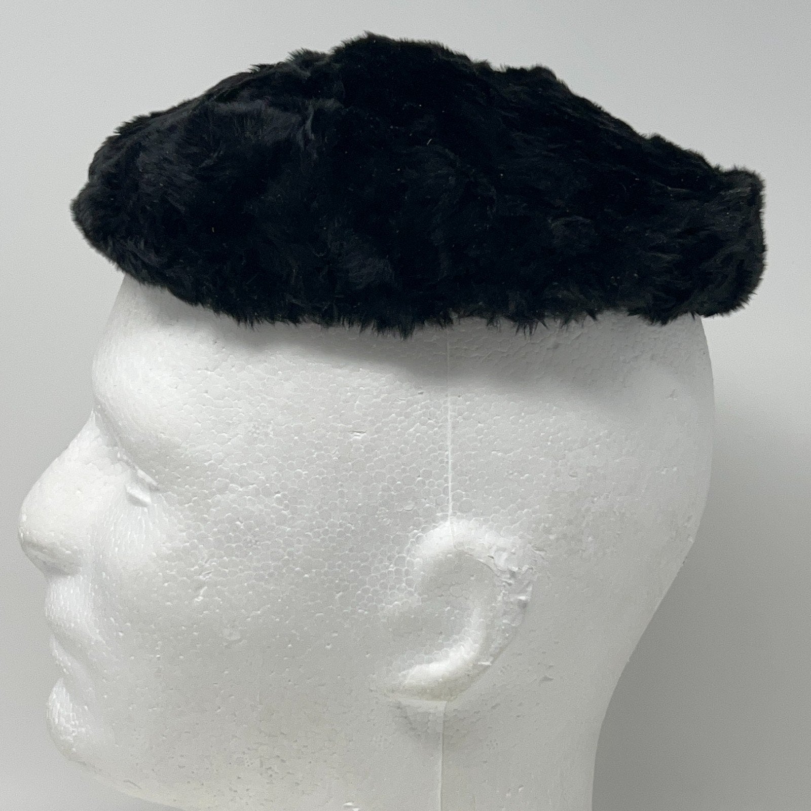 Saks Fifth Avenue pillbox hat in black vintage style viewed from the side on a mannequin head