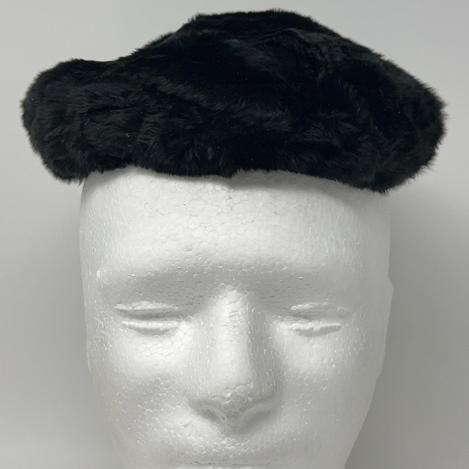 Saks Fifth Avenue black pillbox hat from the 1960s, shown from the front on a mannequin