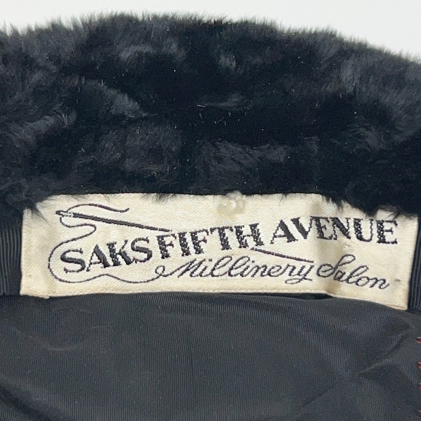 Saks Fifth Avenue black pillbox hat with fur trim, vintage style, viewed from the side