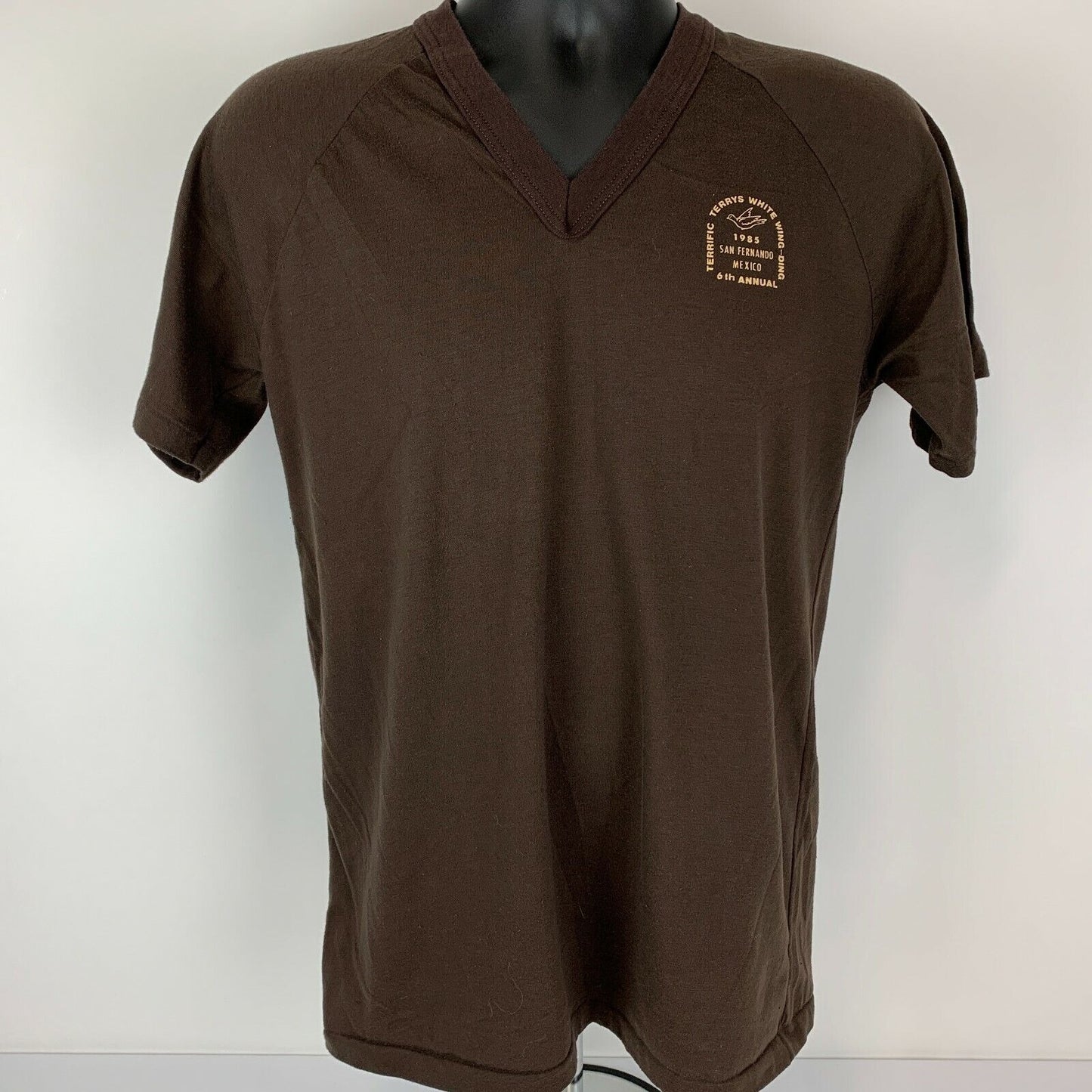 Brown Bomark T-Shirt featuring San Fernando logo on the front, V-neck design, and a relaxed fit