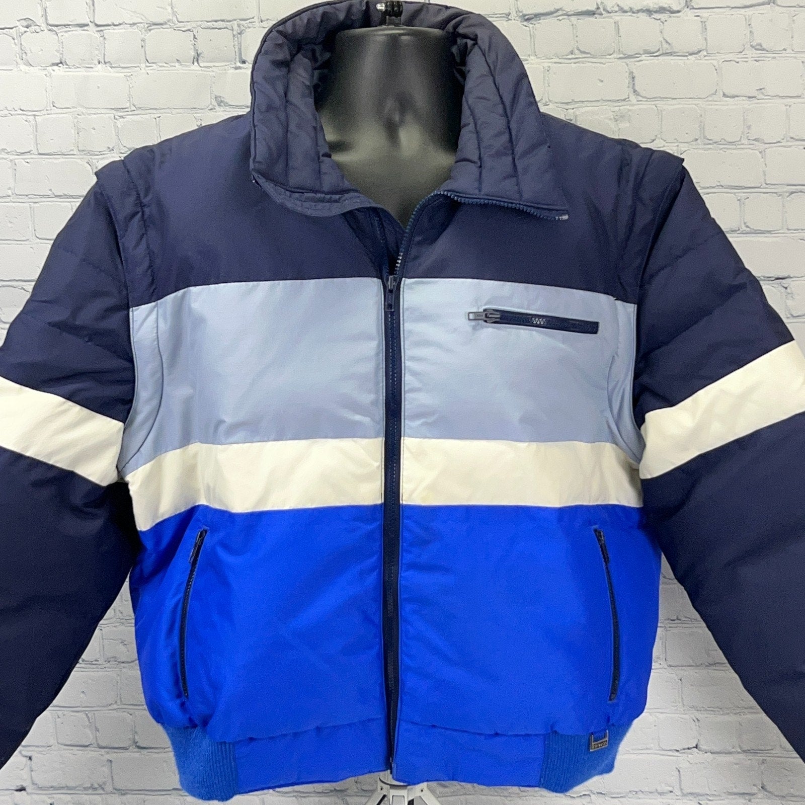 Edelweiss Ski Jacket in Blue and Grey with Front Zip and Logo on Chest, Ideal for Cold Weather