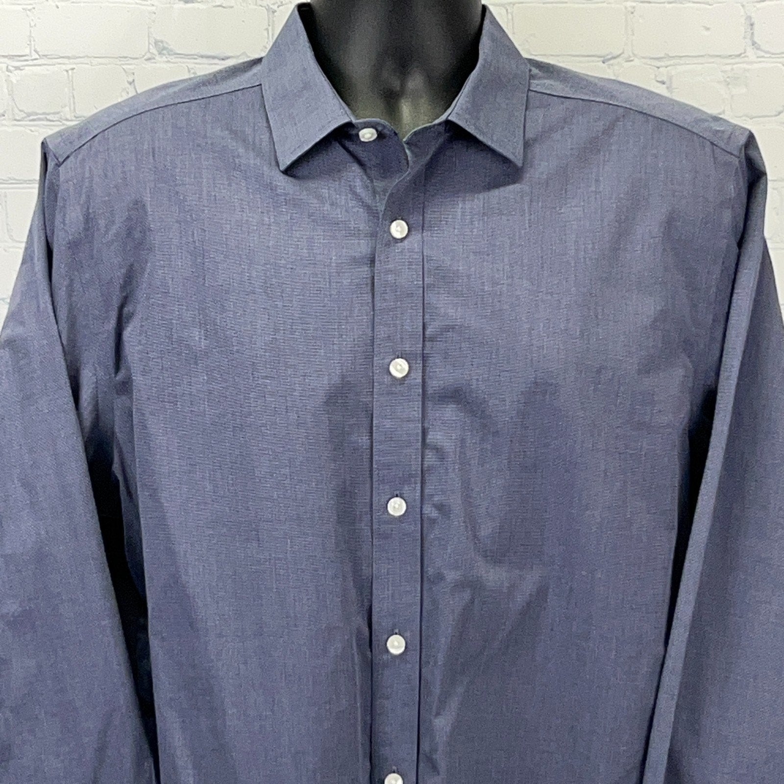 UNTUCKit navy blue long-sleeve dress shirt in size medium, featuring a clean front view with button placket