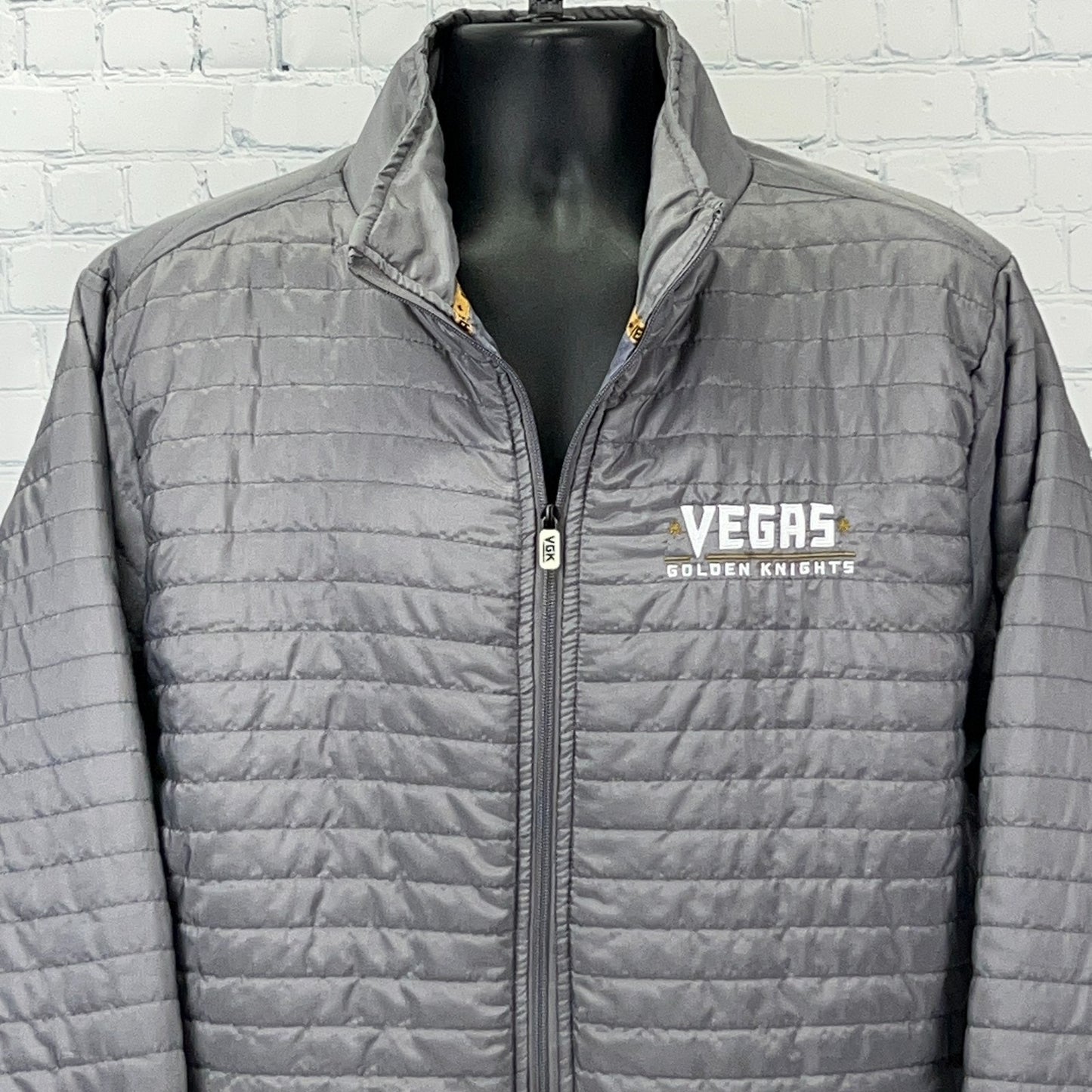 Gray zip-up jacket featuring the Vegas Golden Knights logo on the front for fans