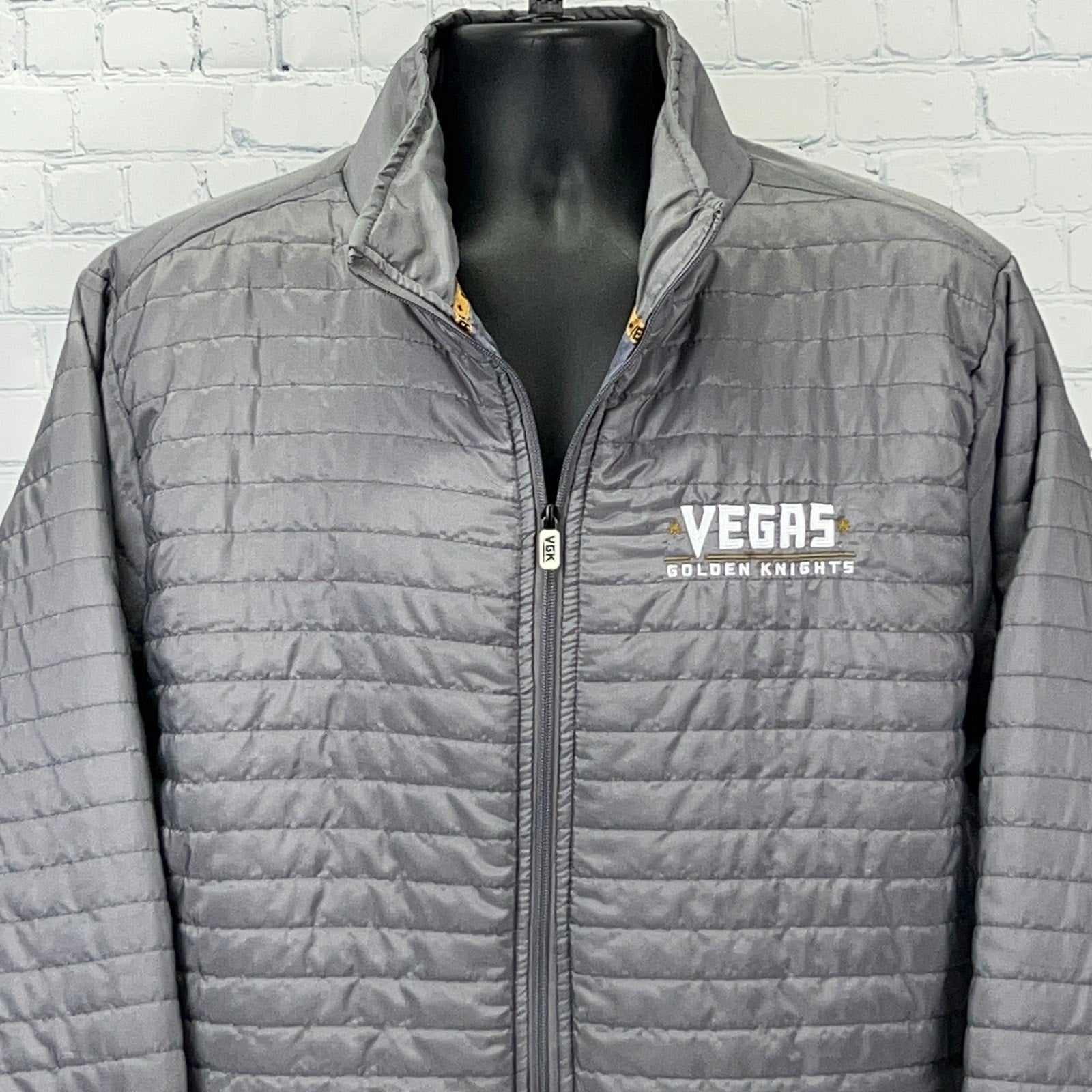 Gray zip-up jacket featuring the Vegas Golden Knights logo on the front for fans