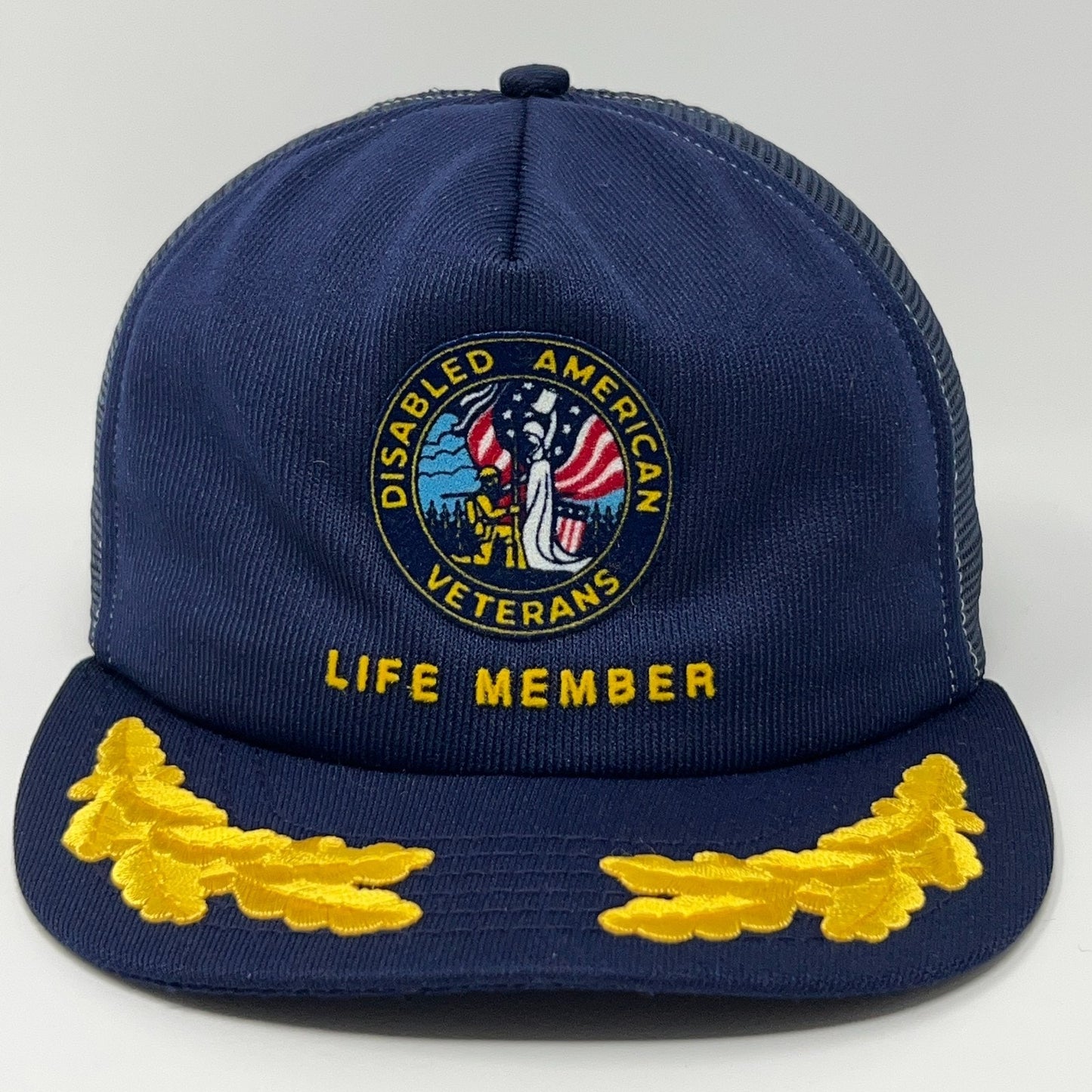 Navy blue cap with Disabled American Veterans logo, Life Member text, and yellow oak leaf embroidery.
