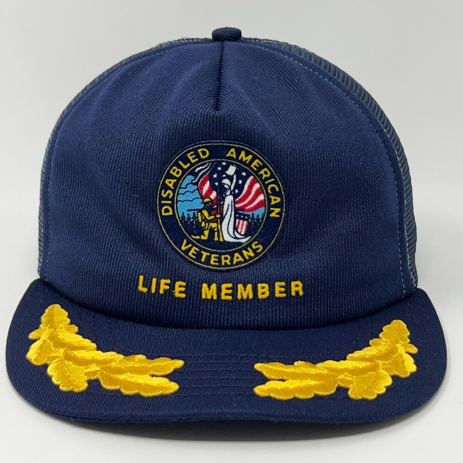 Navy blue cap with Disabled American Veterans logo, Life Member text, and yellow oak leaf embroidery.