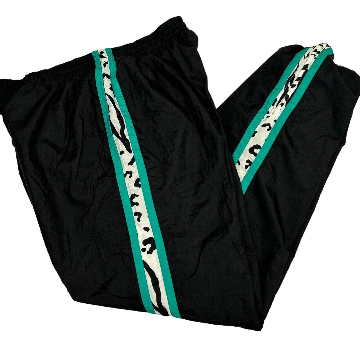 Vintage 90s black track pants with teal and leopard stripes, side view showcasing elastic waistband