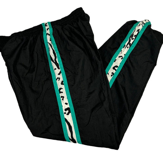 Vintage 90s black track pants with teal and leopard stripes, side view showcasing elastic waistband