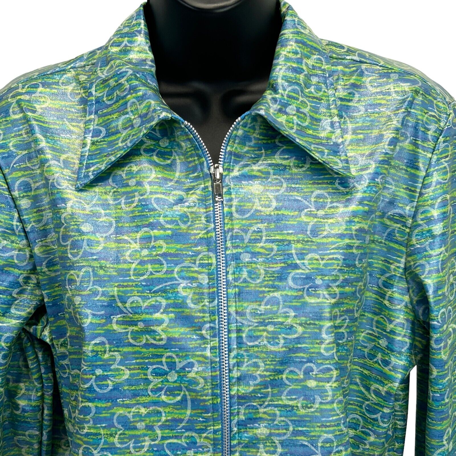 Front view of Vintage 90s floral print jacket by 5-7-9 in blue and green colors, featuring a zipper and large collar.