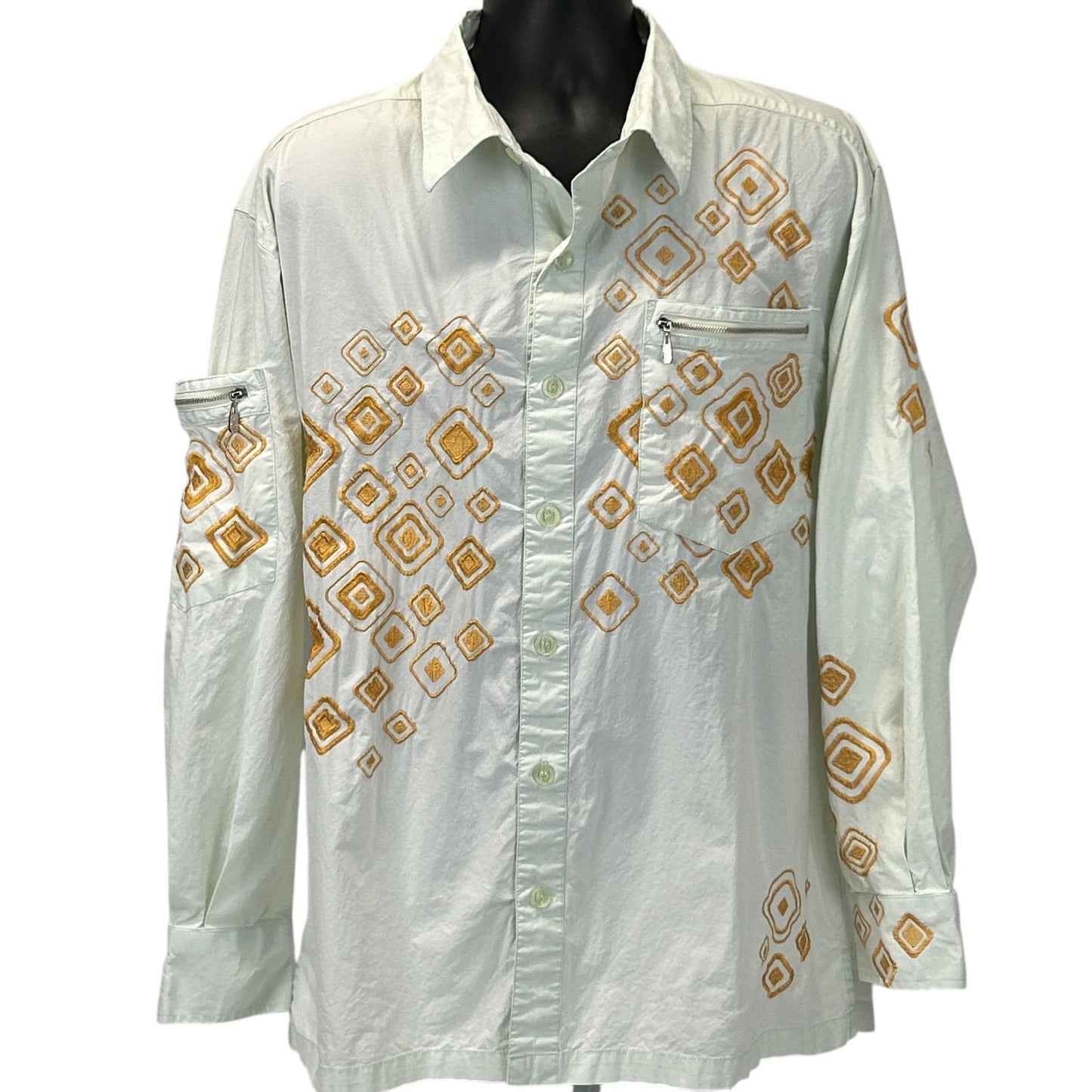 White Prestige shirt with vintage 90s orange geometric designs, featuring a chest pocket and long sleeves