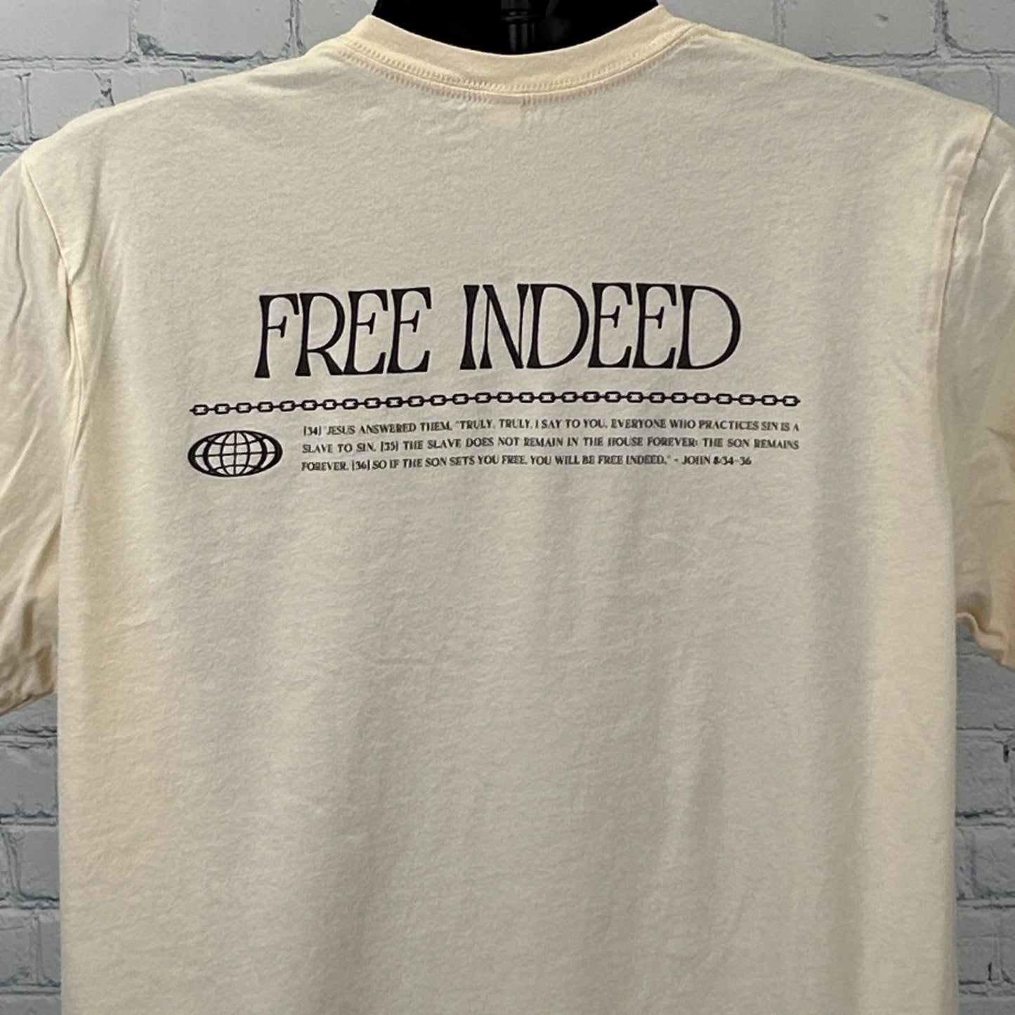 Bella + Canvas Christian T-Shirt in cream with 'Free Indeed' graphic on the back and verse detail