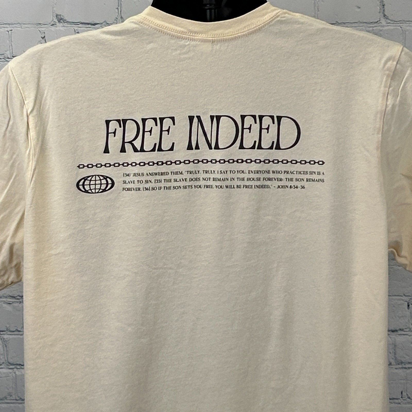 Bella + Canvas Christian T-Shirt in cream with 'Free Indeed' graphic on the back and verse detail