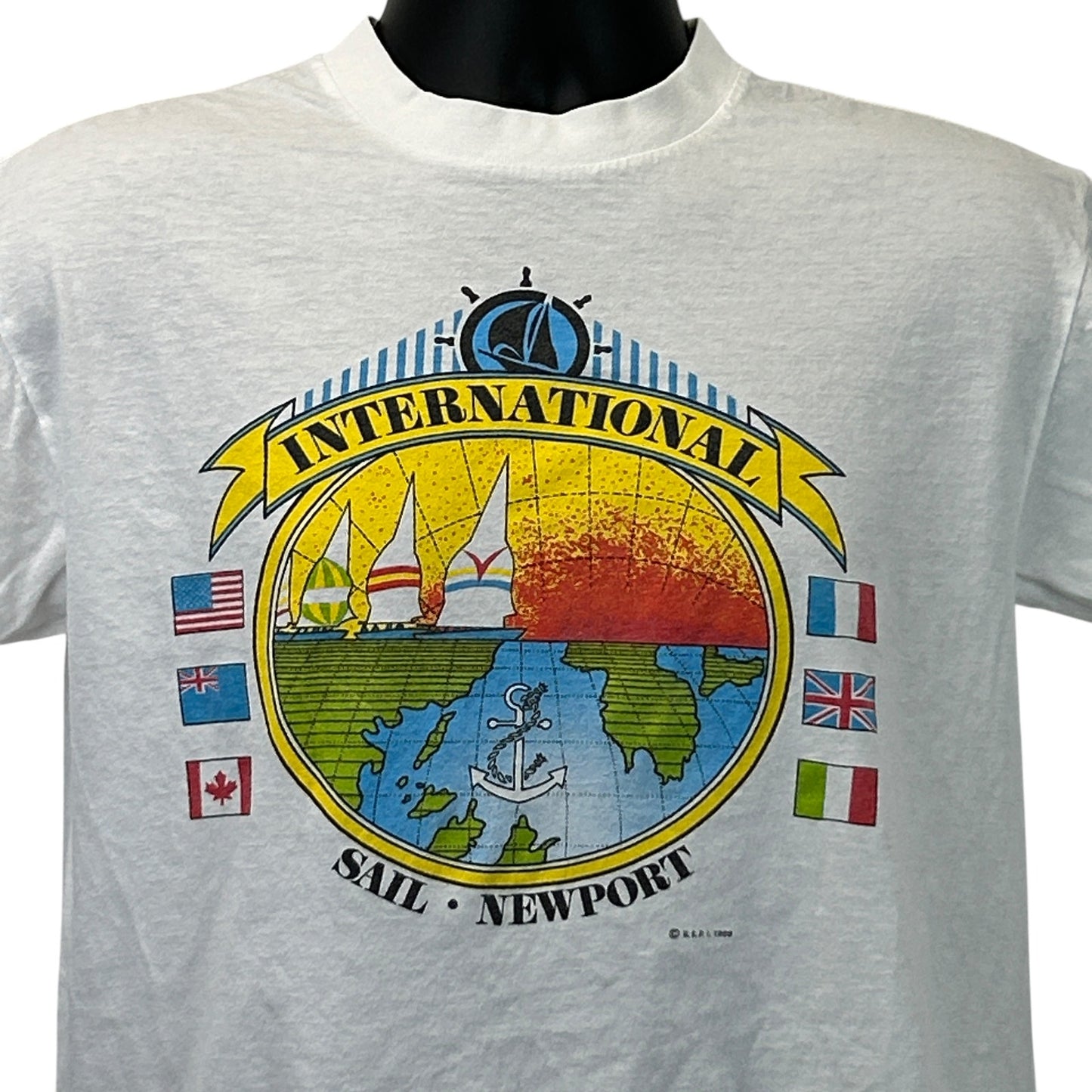 Vintage white T-shirt featuring the logo 'International Sail Newport' with colorful sailboats and flags