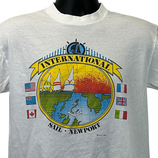 Vintage white T-shirt featuring the logo 'International Sail Newport' with colorful sailboats and flags