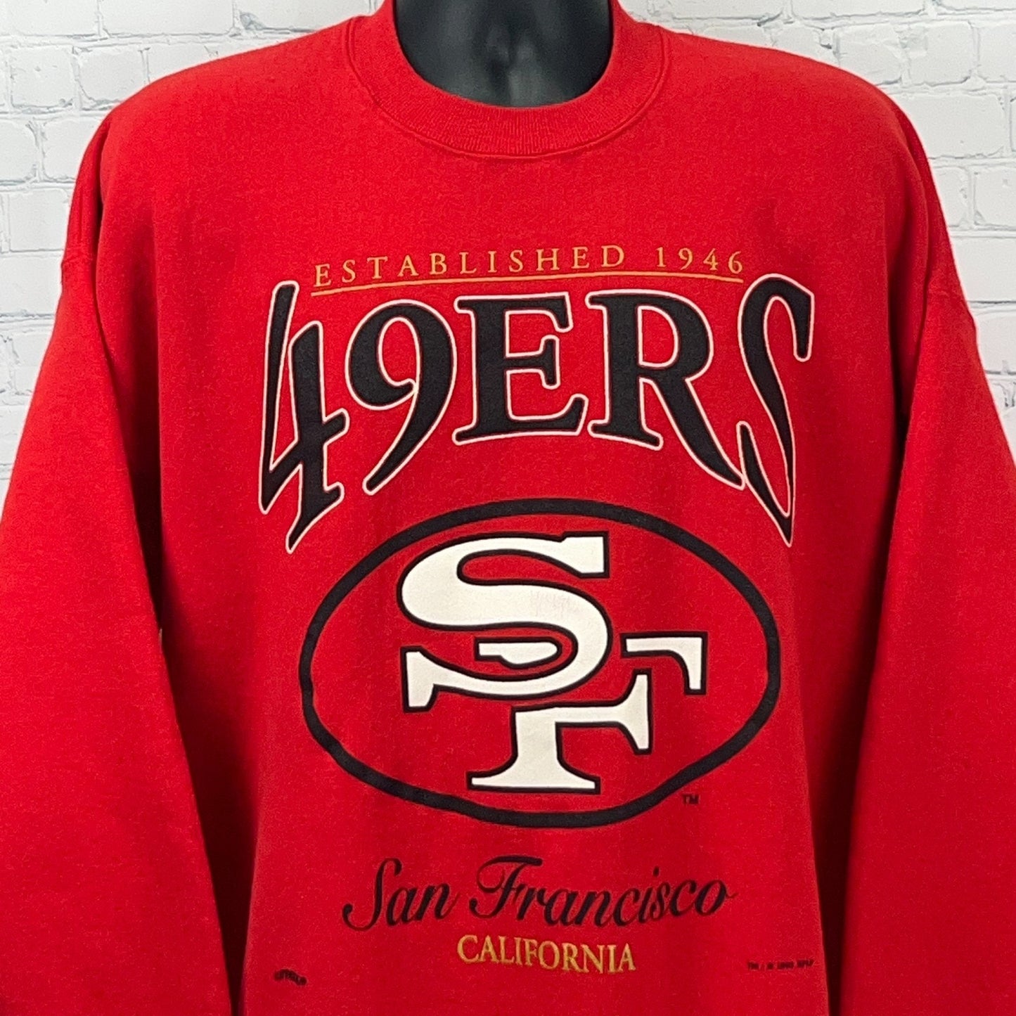 Vintage red San Francisco 49ers sweatshirt with large graphic logo and established year 1946