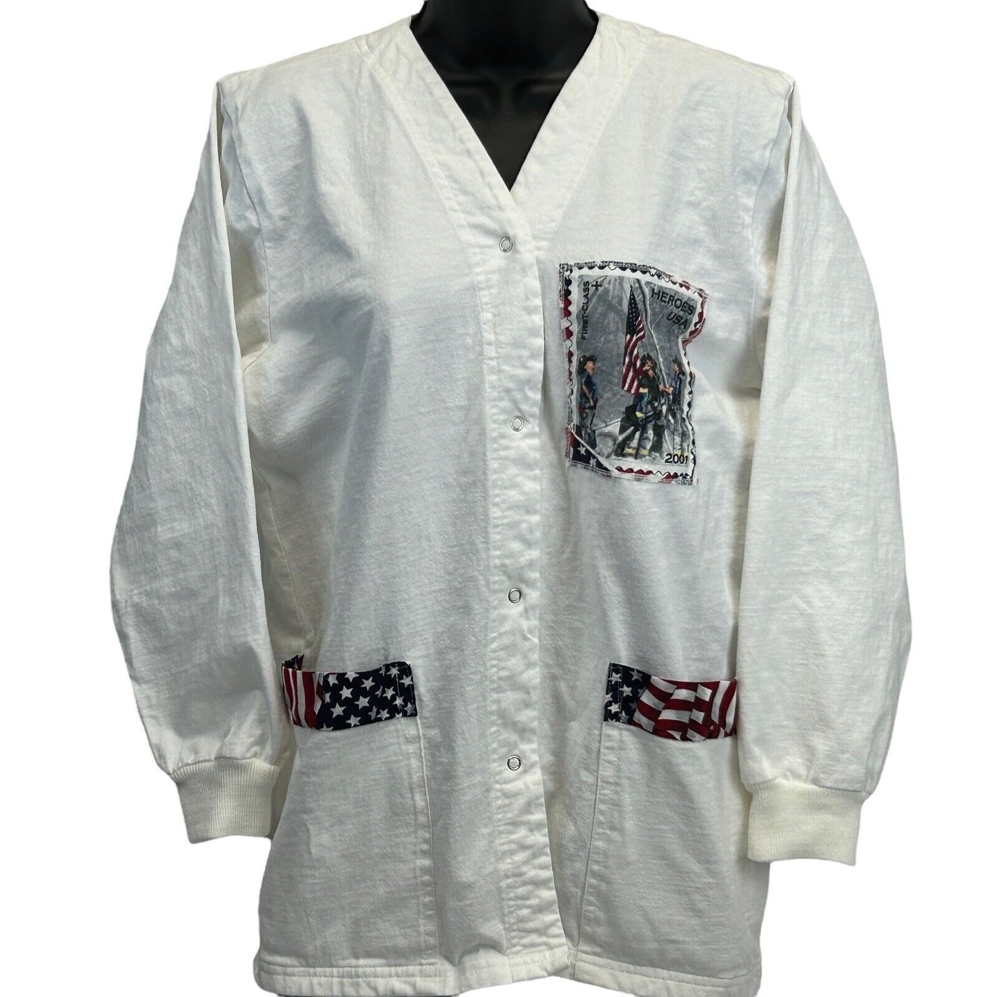 Vintage white scrub jacket featuring a front pocket with patriotic design and striped accents on pockets