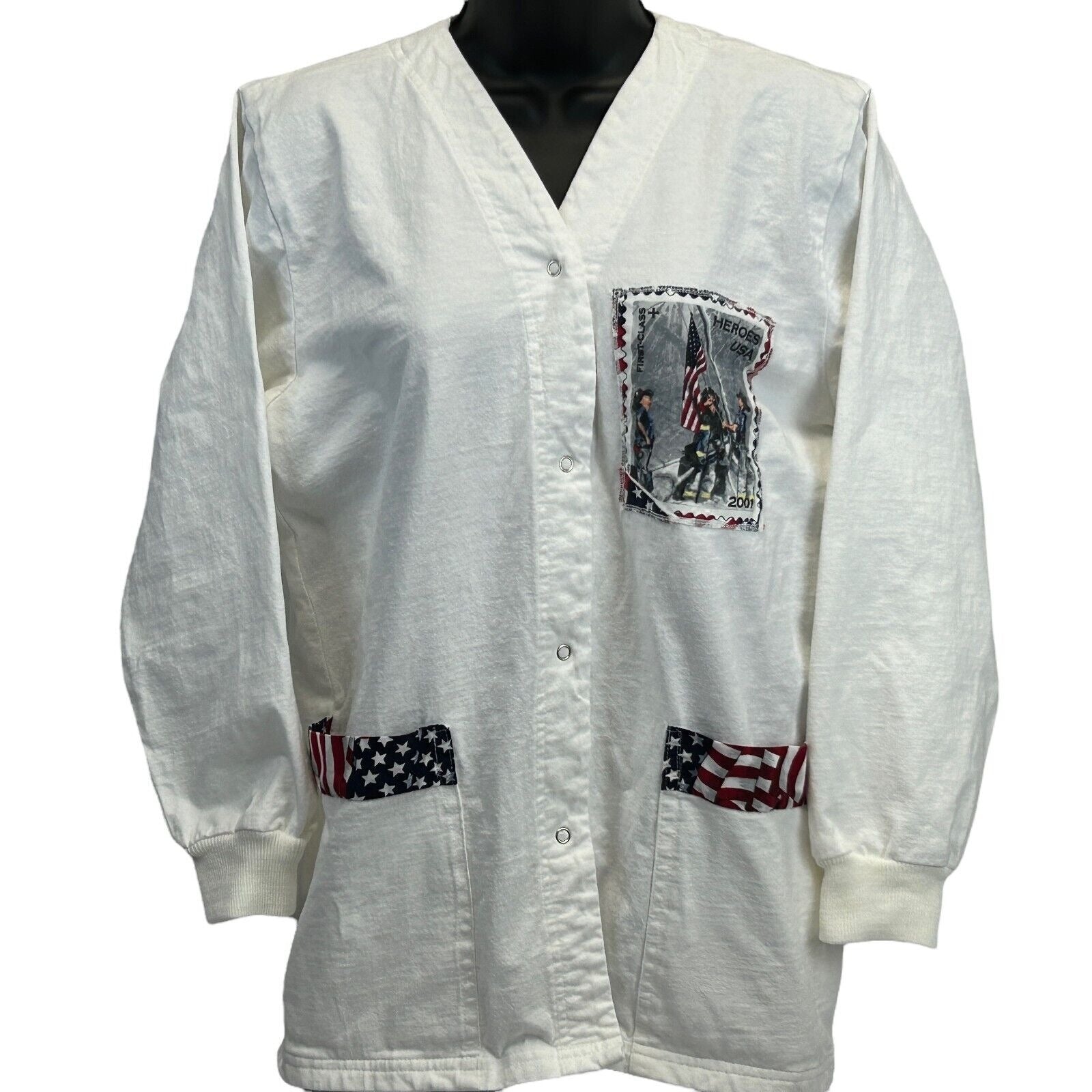 Vintage white scrub jacket featuring a front pocket with patriotic design and striped accents on pockets
