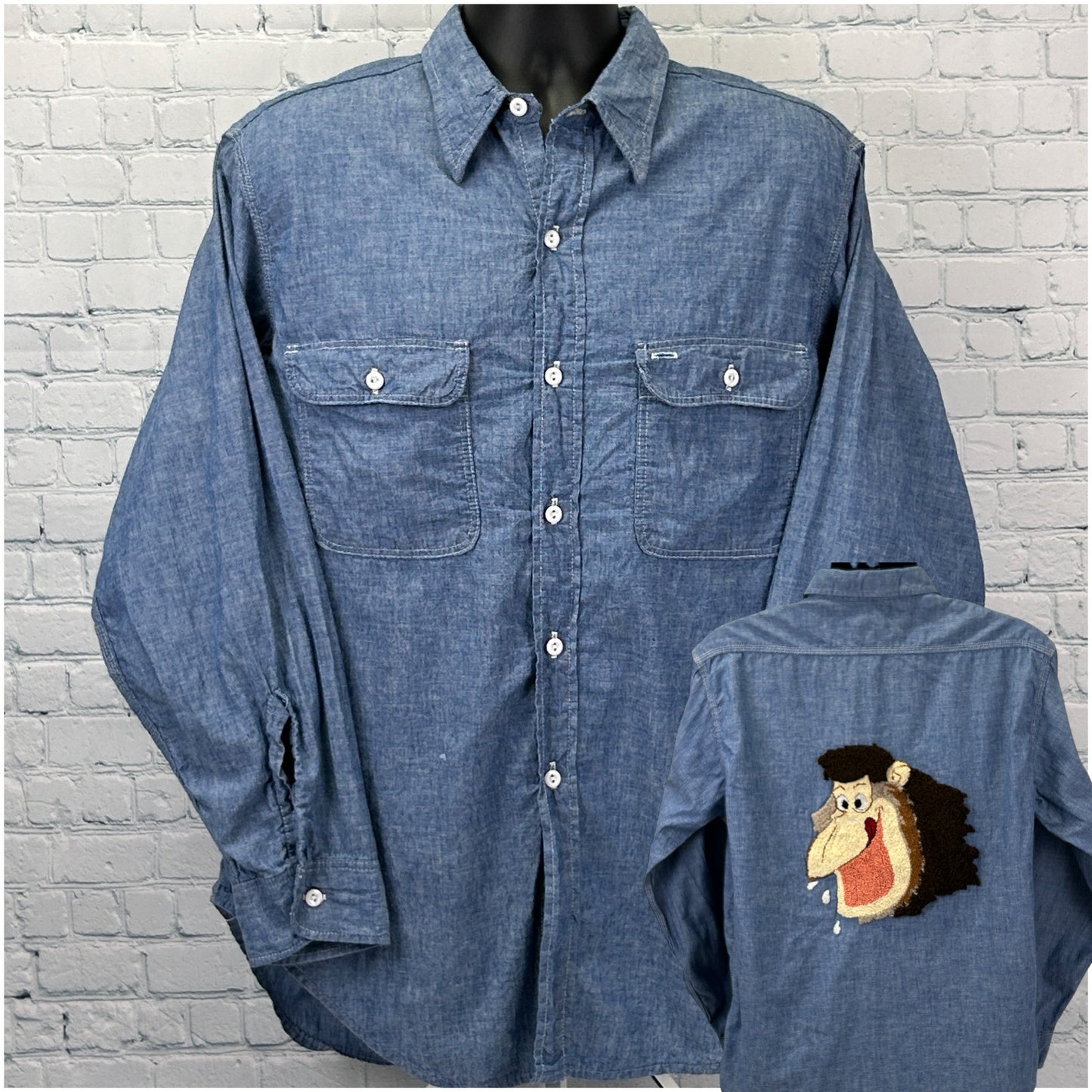 Men's denim vintage shirt in blue featuring front pockets and a playful monkey logo on the back