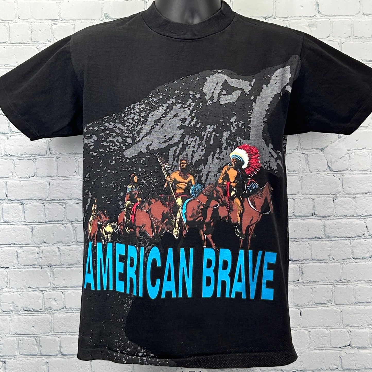 Vintage T Shirt in black with a bold graphic of Native American riders and the text American Brave on the front
