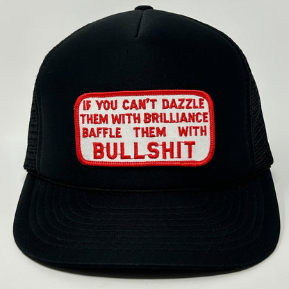 Black Vintage Trucker Hat with a bold red and white patch saying 'If you can't dazzle them with brilliance baffle them with bullshit'