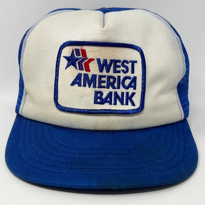Front view of a Vintage Trucker Hat in blue and cream with West America Bank logo