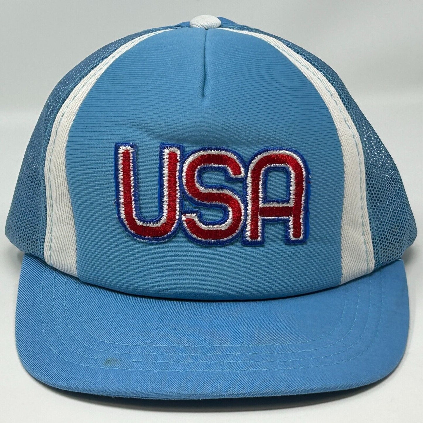 Front view of a blue Young An hat featuring an embroidered USA logo in red and white