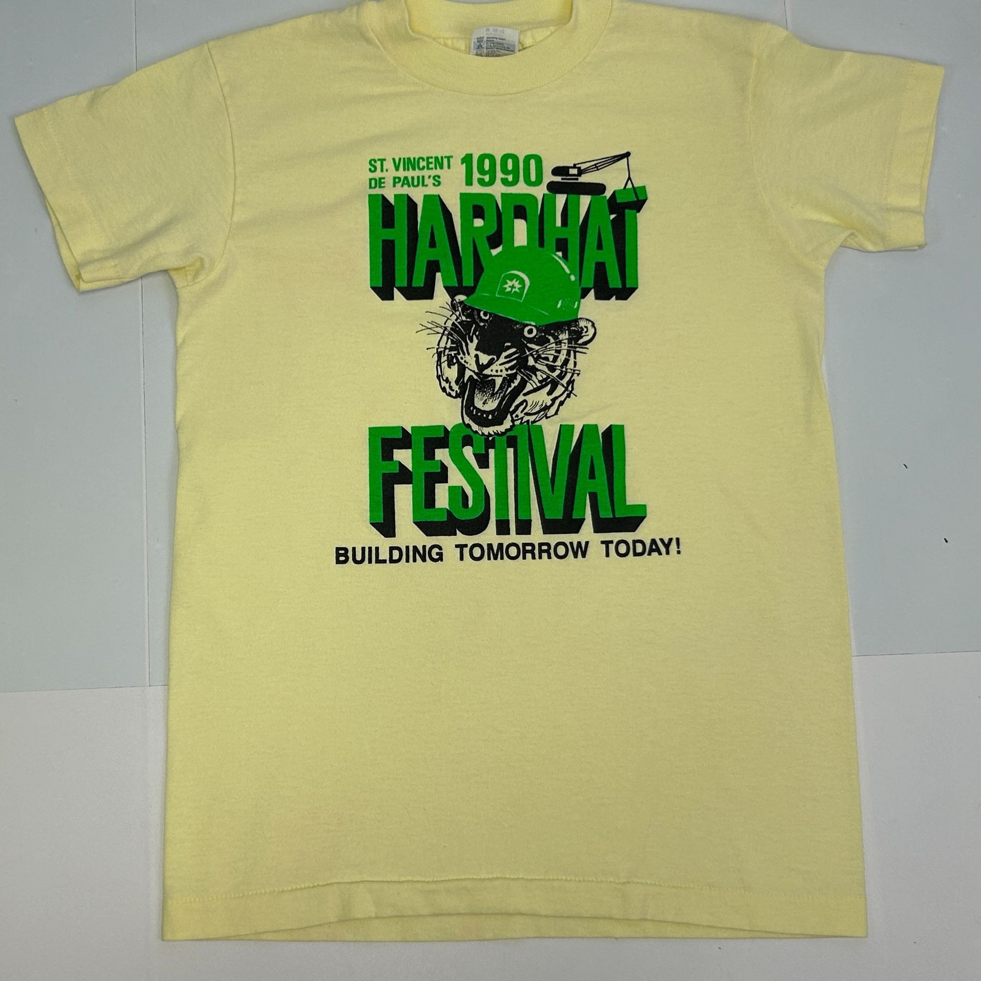 Front view of Hanes yellow T-Shirt featuring Vincent De Pauls Festival graphic with a tiger and hard hat design