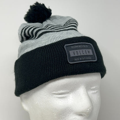 Volcom striped beanie in gray and black with pom-pom and logo patch on the front