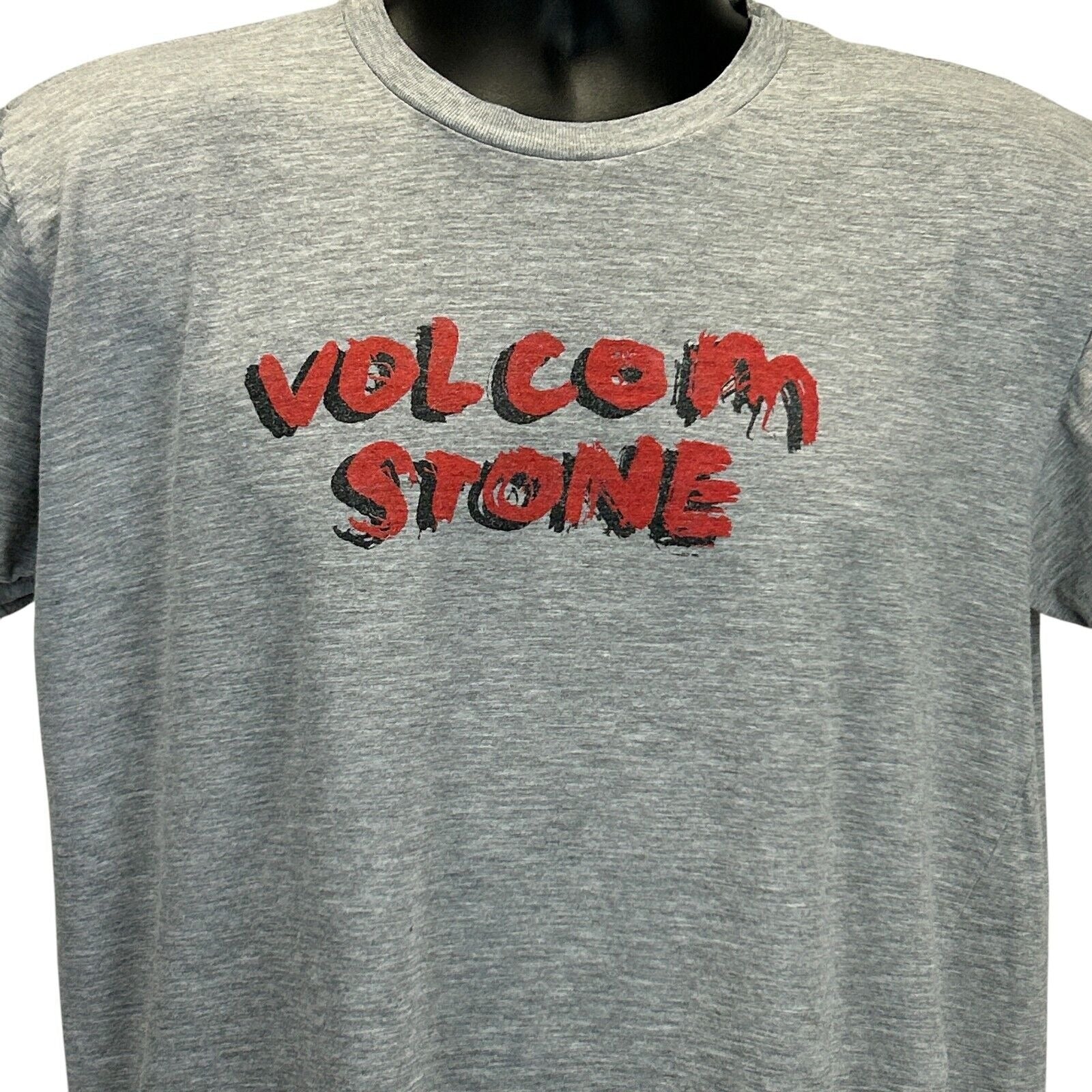 Front view of gray Volcom T-shirt featuring bold red Volcom Stone logo in a stylish design